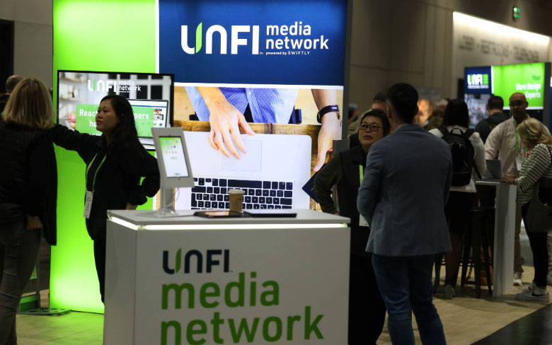 People gathered UNFI Media Network booth at show