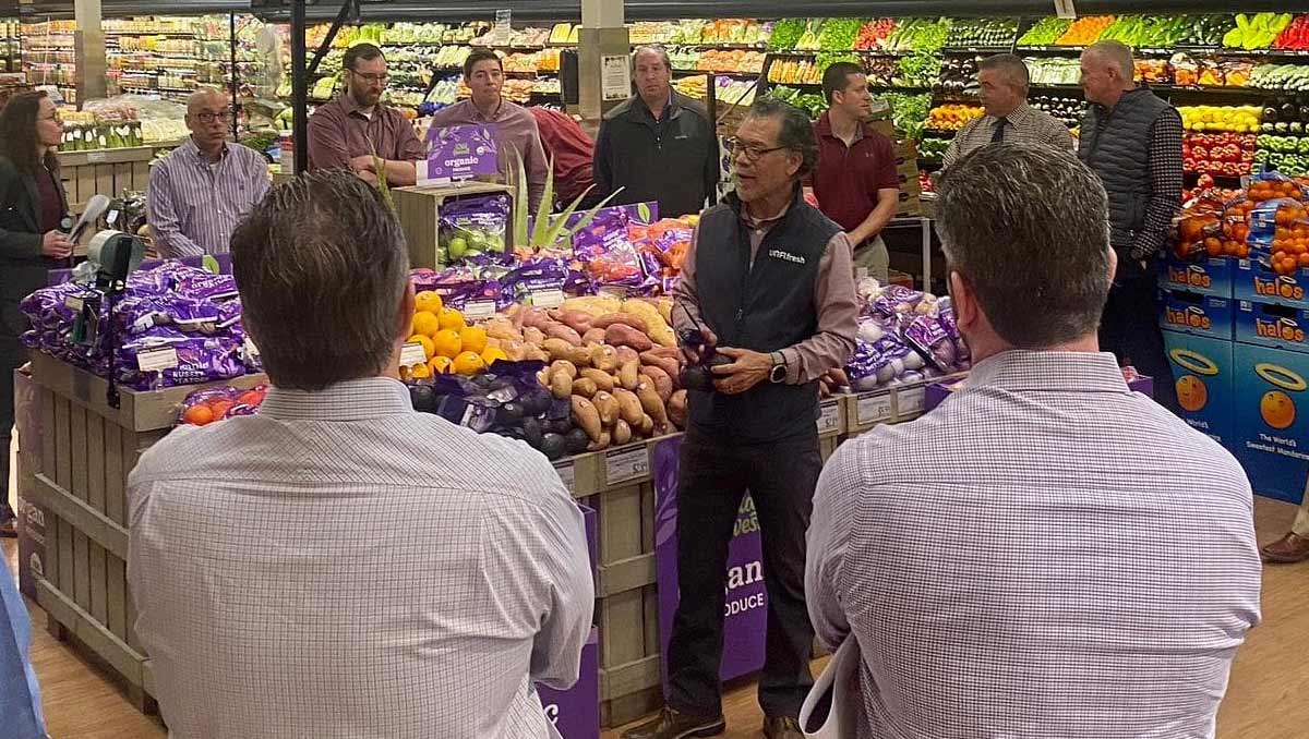 UNFI representative speaking to grocery store employees