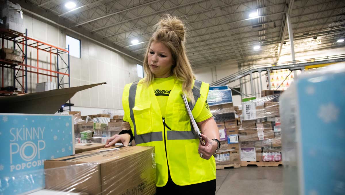 UNFI warehouse worker scanning in products